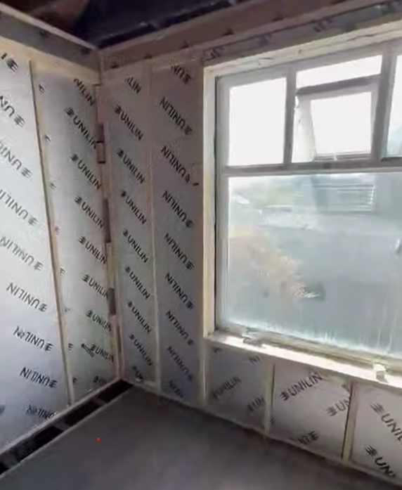 Insulated stud wall, boarding underway